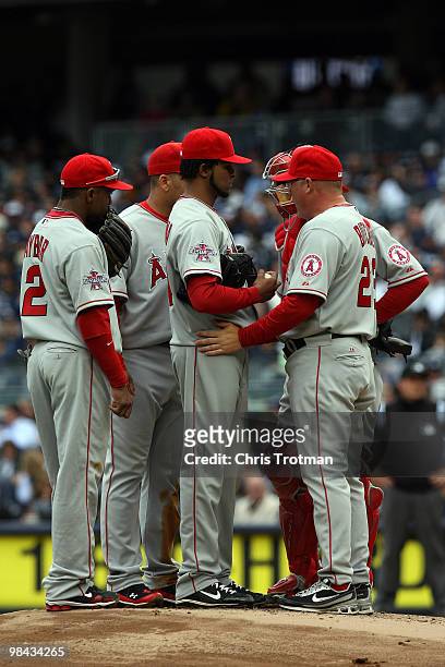 Pitching coach Mike Butcher talks with starting pitcher Ervin Santana of the Los Angeles Angels of Anaheim during a visit to the mound against the...