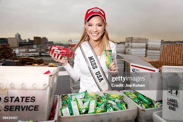 Miss USA Kristen Dalton packs goody bags for overseas troops at the Intrepid Sea-Air-Space Museum on April 13, 2010 in New York City.