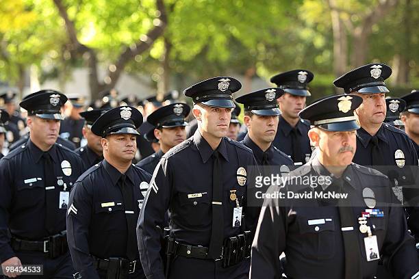 Los Angeles police officers follow a mule-drawn funeral wagon carrying the remains of 45-year-old Los Angeles police SWAT officer and Marine...