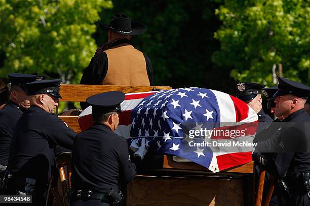 Los Angeles police officers remove the casket carrying the remains of 45-year-old Los Angeles police SWAT officer and Marine reservist Robert J....