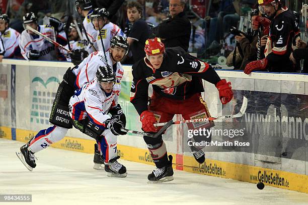 David Wolf of Hannover and Carl Corazzini of Ingolstadt battle for the puck during the third DEL play off semi final match between Hannover Scorpions...