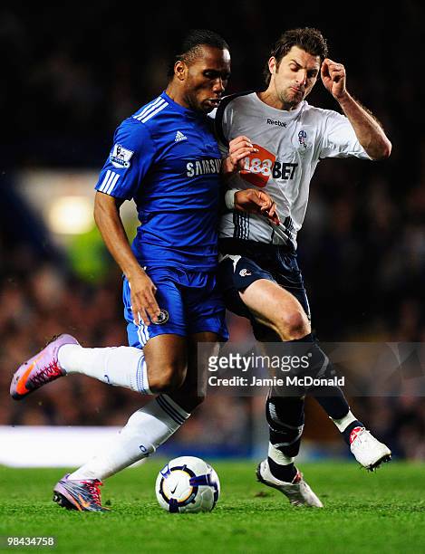 Sam Ricketts of Bolton Wanderers challenges Didier Drogba of Chelsea during the Barclays Premier League match between Chelsea and Bolton Wanderers at...