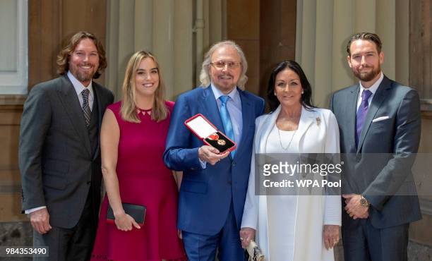 Singer and songwriter Barry Gibb, with his wife, Linda and children, Michael , Alexandra and Ashley at Buckingham Palace, London, after he was...