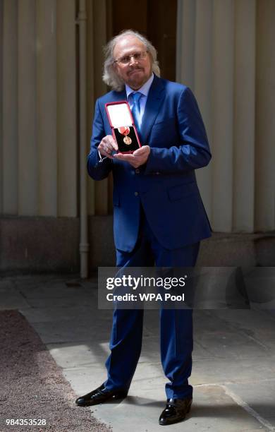 Singer and songwriter Barry Gibb poses for a picture after being Knighted by Prince Charles, Prince of Wales during investitures at Buckingham Palace...