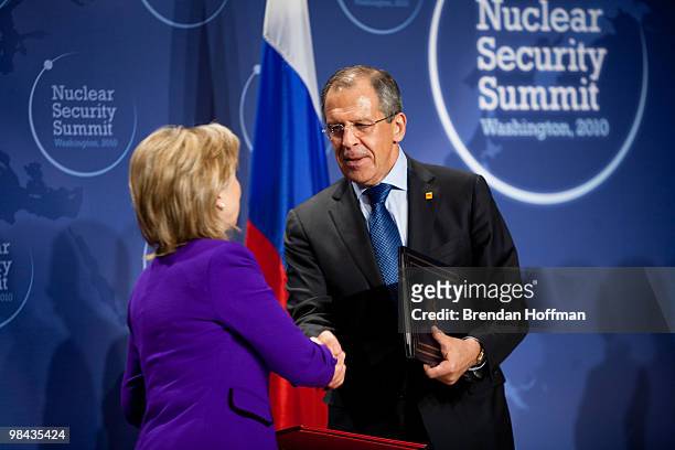 Secretary of State Hillary Clinton and Russian Foreign Minister Sergey Lavrov shake hands after signing a plutonium disposition protocol at the...