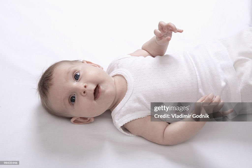 High angle portrait of baby lying on back