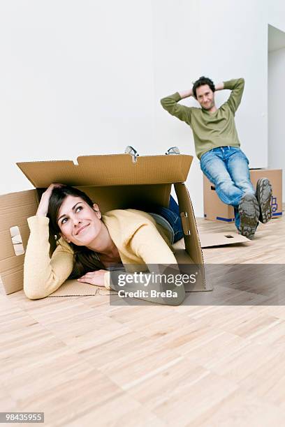 young couple taking break from moving into new home - naughty wife fotografías e imágenes de stock