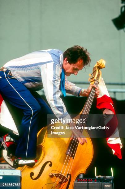 American musician Ray Campi balances on his upright acoustic bass as he performs at the Lincoln Center Out of Doors Rockabilly Jamboree in Damrosch...