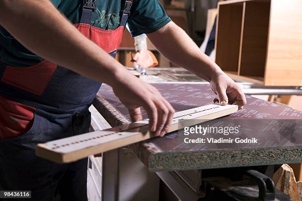 detail of worker in furniture workshop measuring batten - batten stock-fotos und bilder