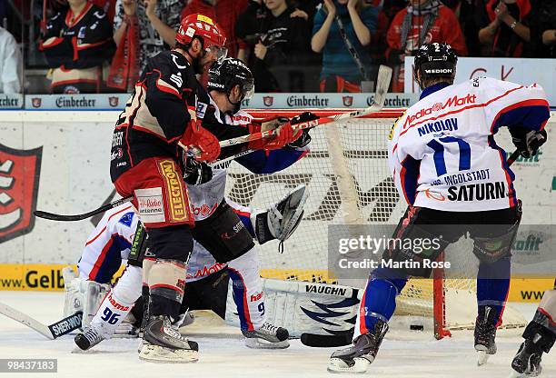 Chris Herperger of Hannover scores his team's 4th goal over Ingolstadt goalkeeper Dimitri Paetzold during the third DEL play off semi final match...