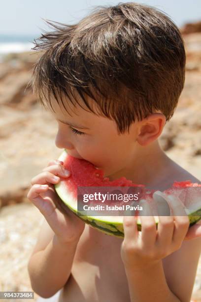 boy eating a slice of watermelon - isabel pavia stockfoto's en -beelden