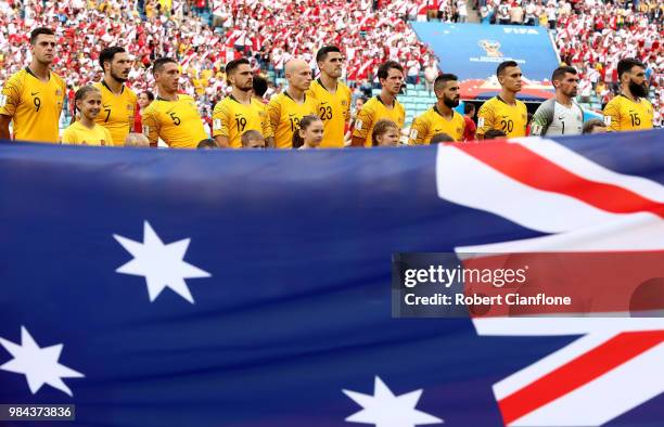 The Australia players line up for national anthem behind a large Australia flag prior to the 2018 FIFA World Cup Russia group C match between...