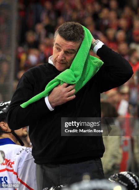 Greg Thomson, head coach of Ingolstadt recats after he was hit by a beer during the third DEL play off semi final match between Hannover Scorpions...