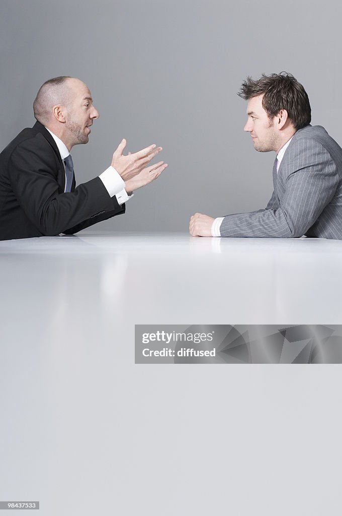 Two businessmen sitting at conference table