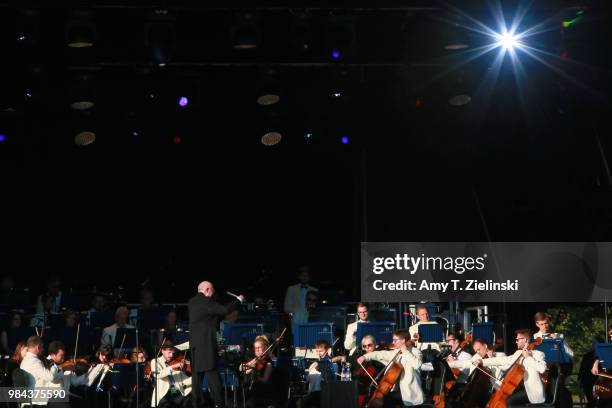 Conductor Paul Bateman leads the Royal Philharmonic Concert Orchestra during The Heritage Live Concert Series on stage at Kenwood House on June 24,...