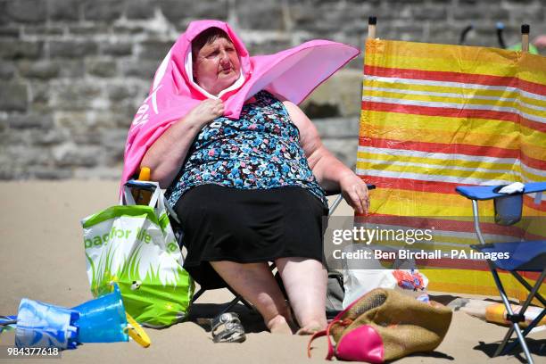 Woman relaxes on the beach at Barry Island, Vale of Glamorgan, Wales, as temperatures are predicted to increase this week.