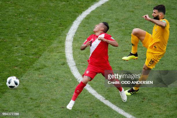 Australia's midfielder Mile Jedinak fouls Peru's midfielder Christian Cueva during the Russia 2018 World Cup Group C football match between Australia...