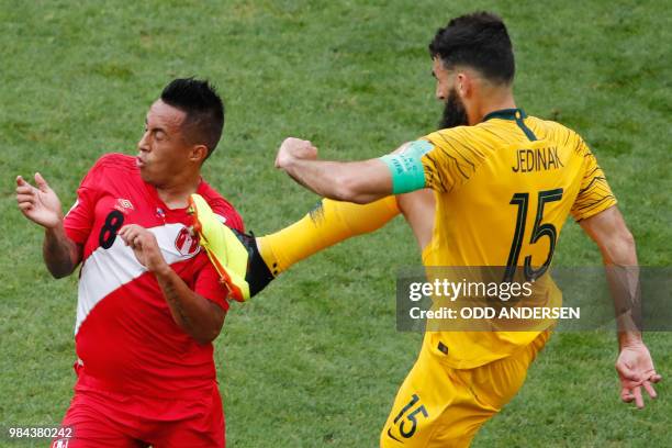 Australia's midfielder Mile Jedinak fouls Peru's midfielder Christian Cueva during the Russia 2018 World Cup Group C football match between Australia...