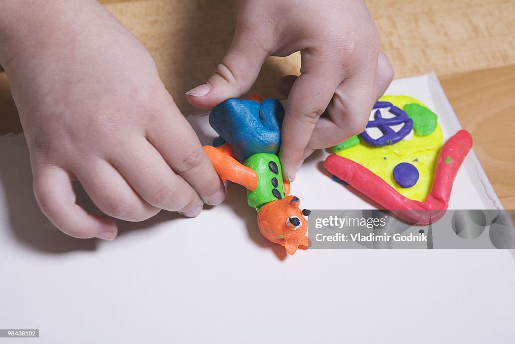 Close-up of young girl playing with modelling clay