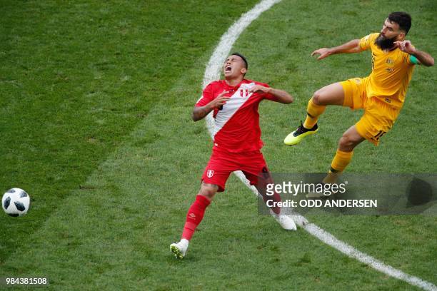 Australia's midfielder Mile Jedinak fouls Peru's midfielder Christian Cueva during the Russia 2018 World Cup Group C football match between Australia...