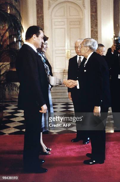 Emperor Hirohito greets Egyptian President Hosni Mubarak and his wife Suzanne Mubarak prior to the official welcoming ceremony at the guesthouse on...
