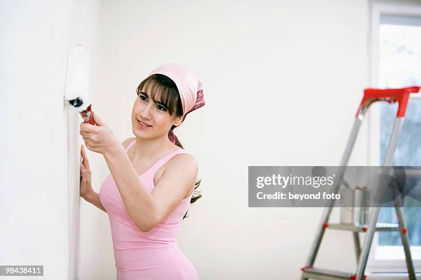 teenage girl decorating walls of her new home - fotohandy stock pictures, royalty-free photos & images