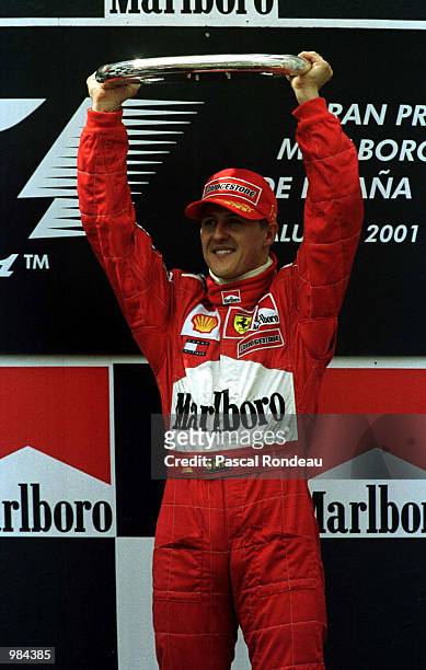 Michael Schumacher of Germany and Ferrari celebrates with the trophy after winning the Spanish Formula One Grand Prix at the Circuit de Catalunya,...