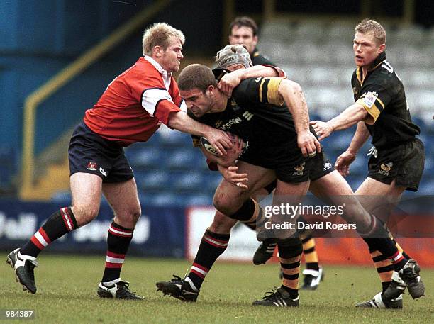 Joe Worsley of Wasps powers through the tackle of Jake Boer and Simon Manix of Gloucester during the match between London Wasps and Gloucester in the...