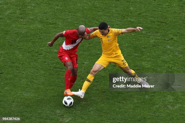 Andre Carrillo of Peru is challenged by Tom Rogic of Australia during the 2018 FIFA World Cup Russia group C match between Australia and Peru at...