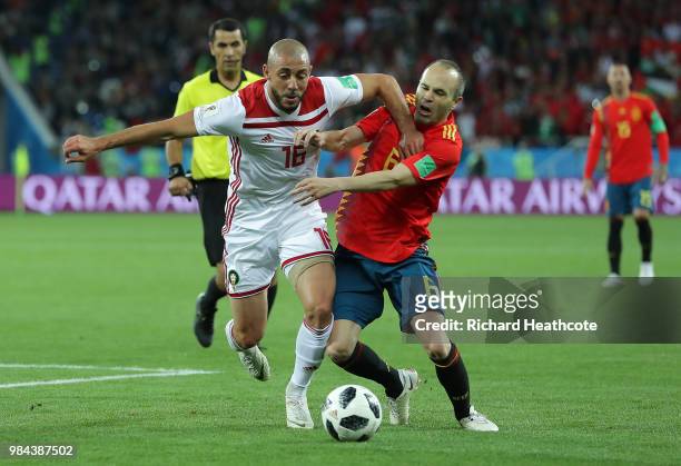 Noureddine Amrabat of Morocco battles with Andres Iniesta of Spain during the 2018 FIFA World Cup Russia group B match between Spain and Morocco at...