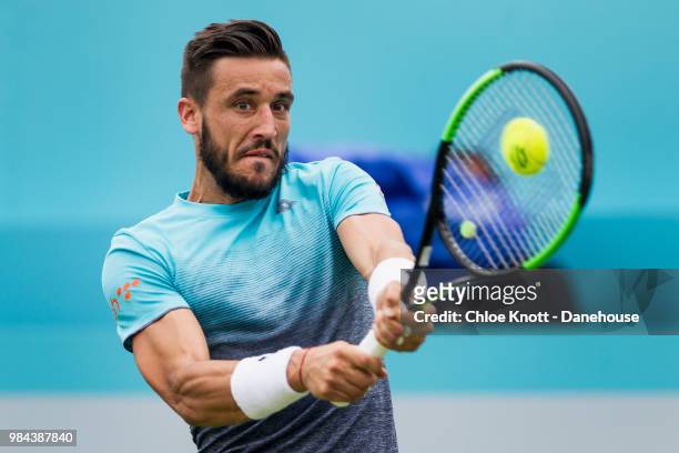 Damir Dzumhur of Bosnia plays a backhand shot during his match against Grigor Dimitrov of Bulgaria on day two of the Fever-Tree Championships at...