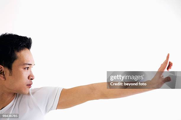 asian man doing martial arts exercises - studiofoto stock pictures, royalty-free photos & images