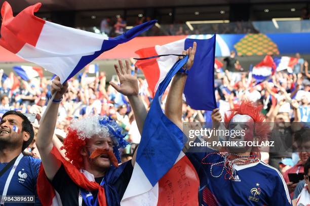 France's fans wearing fancy wigs gesture before the Russia 2018 World Cup Group C football match between Denmark and France at the Luzhniki Stadium...