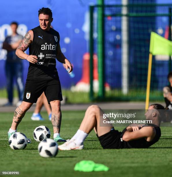 Uruguay's midfielder Cristian Rodriguez and Uruguay's defender Gaston Silva take part in a training session of Uruguay's national football team at...