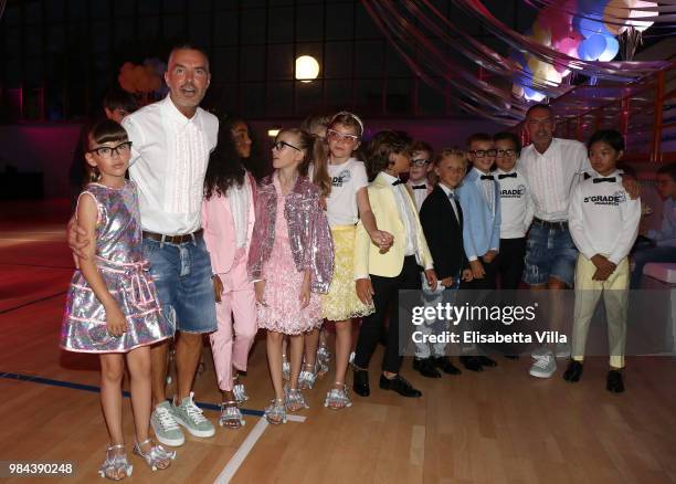 Fashion designers, founders and owners of Dsquared2 Dan Caten and Dean Caten pose with models at the Caten Hight School Prom DSquared2 as a part of...