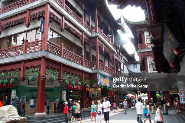 Street in amongst the traditional Chinese architecture of Yu Yuan Garden in Shanghai, China. This area draws a lot of tourists, both mainland and...