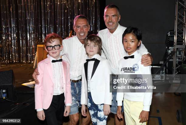 Fashion designers, founders and owners of Dsquared2 Dan Caten and Dean Caten pose with models at the Caten Hight School Prom DSquared2 as a part of...