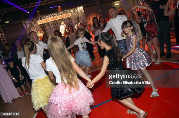 Fashion designers, founders and owners of Dsquared2 Dan Caten and Dean Caten dance with models at the Caten Hight School Prom DSquared2 as a part of...
