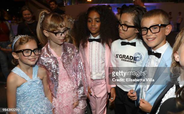 Models pose for a photo at the Caten Hight School Prom DSquared2 as a part of Pitti Bimbo Kids Fashion Week at Palamattioli on June 21, 2018 in...