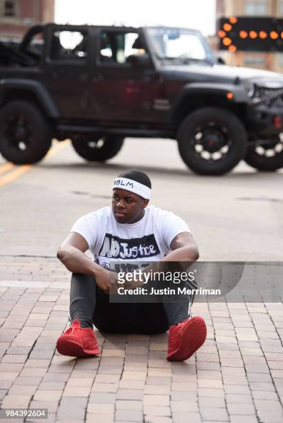 Marcus King of Turtle Creek sits in the street as he joins protestors to block a major downtown intersection a day after the funeral of Antwon Rose...
