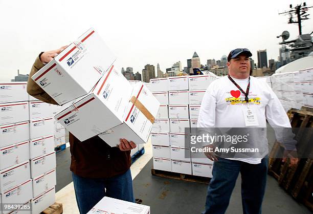 Volunteers pack goody bags for overseas troops at the Intrepid Sea-Air-Space Museum on April 13, 2010 in New York City.