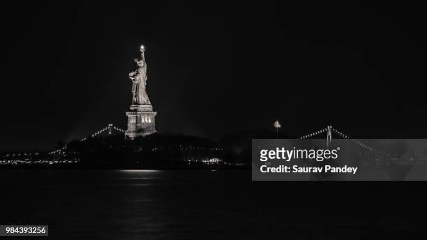 statue of liberty against the verrazano-narrows bridge - verrazano stock pictures, royalty-free photos & images