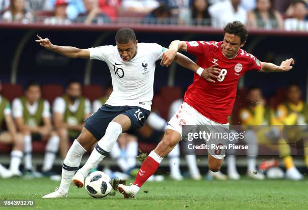 Kylian Mbappe of France is tackled by Thomas Delaney of Denmark during the 2018 FIFA World Cup Russia group C match between Denmark and France at...