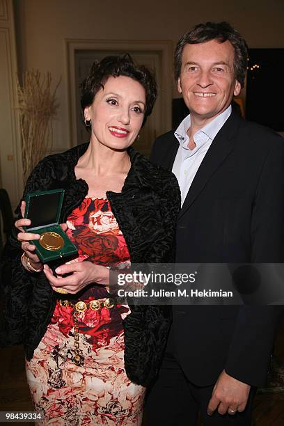 Singer Luz Casal poses with Olivier Montfort after being decorated with the 'Honor medal of the city of Paris' by Bertrand Delanoe at Hotel de Ville...