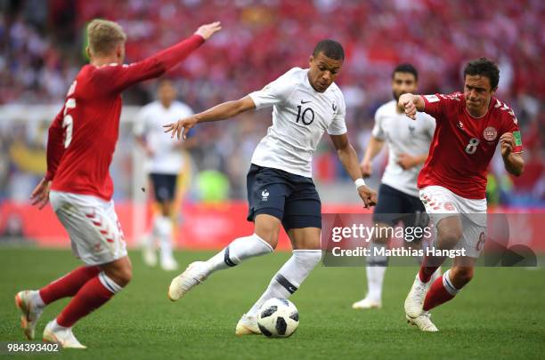 Kylian Mbappe of France is challenged by Thomas Delaney of Denmark during the 2018 FIFA World Cup Russia group C match between Denmark and France at...