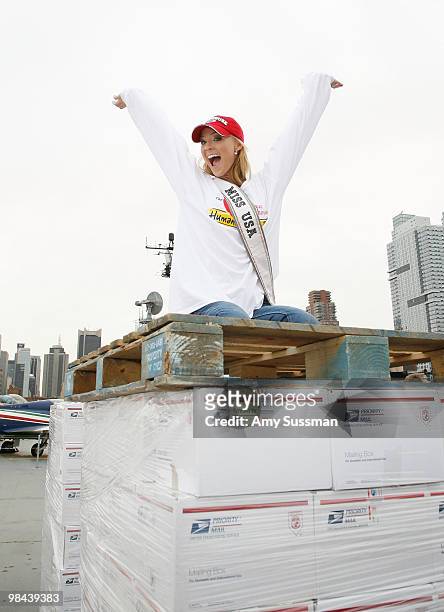 Miss USA Kristen Dalton packs goody bags for overseas troops at the Intrepid Sea-Air-Space Museum on April 13, 2010 in New York City.
