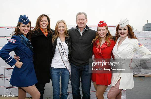 Heather Hart, Miss USA Kristen Dalton and Texas Roadhouse CEO G.J. Hart poses for pictures with the USO Girls before packing goody bags for overseas...