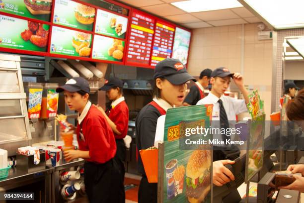 Kentucky Fried Chicken staff at a restaurant on Huai Hai Road and Shaanxi Road in Shanghais downtown shopping district in Shanghai, China. Western...