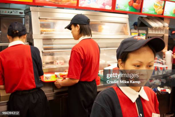 Kentucky Fried Chicken staff at a restaurant on Huai Hai Road and Shaanxi Road in Shanghais downtown shopping district in Shanghai, China. Western...