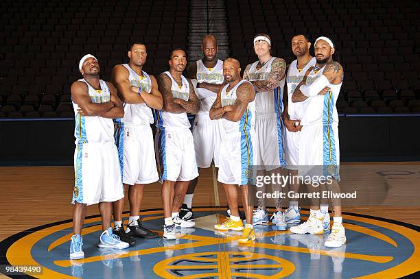 Ty Lawson, Joey Graham, J.R. Smith, Johan Petro, Anthony Carter, Chris Andersen, Malik Allen and Renaldo Balkman of the Denver Nuggets pose for a...